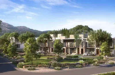 Villa row with the Sahyadri hills behind and a garden with benches